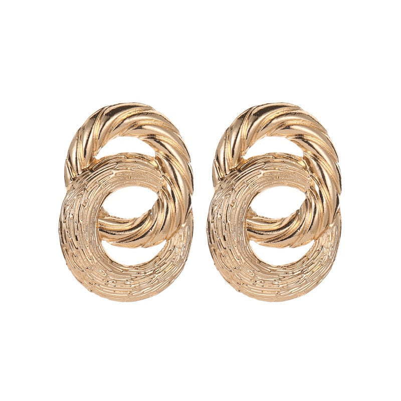 Mila - Boucles d'oreilles rondes dorées au design chic